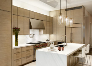 DHD Upper West Side Townhouse Kitchen in neutral tones with a white island with three pendants over, and custom cabinets