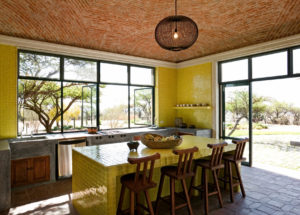 DHD Mexico House Casa Adela Kitchen - yellow tile and island with huge windows and walk out to see the landscape, boveda artisan ceiling