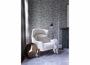 DHD Upper East Side Townhouse Primary Bedroom - Detail of white club chair with decorative pattern wallpaper