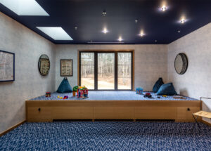 Custom designed blue tone kids playroom with painted ceiling and skylight windows
